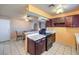 Kitchen features dark wood cabinets, an island, and a dining area at 3091 Liberty Cir, Las Vegas, NV 89121