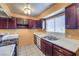 Kitchen with dark wood cabinets, white countertops, and tiled floors at 3091 Liberty Cir, Las Vegas, NV 89121