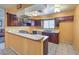 Bright kitchen with dark wood cabinets and tiled floor at 3091 Liberty Cir, Las Vegas, NV 89121