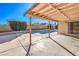 Inviting backyard pool with patio cover and concrete decking at 3091 Liberty Cir, Las Vegas, NV 89121