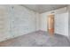 Bedroom featuring exposed concrete wall and carpet flooring at 353 E Bonneville Ave # 503, Las Vegas, NV 89101