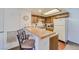 Cozy kitchen with light wood cabinets and a breakfast bar at 3760 Desert Marina Dr # 67, Laughlin, NV 89029