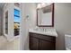 Modern bathroom with dark vanity and large mirror at 39 Cranberry Cove Ct, Las Vegas, NV 89135