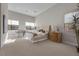 Bright bedroom with tufted headboard, large windows, and carpeted floor at 39 Cranberry Cove Ct, Las Vegas, NV 89135