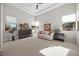 Relaxing bedroom with sitting area, large windows, and dresser at 39 Cranberry Cove Ct, Las Vegas, NV 89135