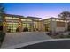 Modern home at dusk showcasing a three-car garage and attractive landscaping at 39 Cranberry Cove Ct, Las Vegas, NV 89135