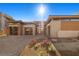 Modern home exterior with stone accents and a paver driveway at 39 Cranberry Cove Ct, Las Vegas, NV 89135