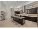 Modern kitchen with dark wood cabinetry, granite island, and stainless steel appliances at 39 Cranberry Cove Ct, Las Vegas, NV 89135