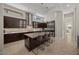 Modern kitchen with dark cabinetry, granite island, and stainless steel appliances at 39 Cranberry Cove Ct, Las Vegas, NV 89135