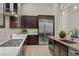 Modern kitchen with dark cabinetry, granite countertops, and stainless steel appliances at 39 Cranberry Cove Ct, Las Vegas, NV 89135