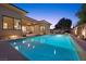 Luxury pool with patio furniture at dusk, surrounded by desert landscaping at 39 Cranberry Cove Ct, Las Vegas, NV 89135