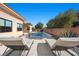 Relaxing pool area with lounge chairs and brick wall at 39 Cranberry Cove Ct, Las Vegas, NV 89135