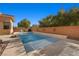 Relaxing pool area with light stone coping and a brick wall at 39 Cranberry Cove Ct, Las Vegas, NV 89135