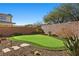 Landscaped backyard with a putting green and desert plants at 39 Cranberry Cove Ct, Las Vegas, NV 89135