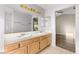 Bathroom with double sink vanity and wood cabinets at 4120 Scotmist Ct, Las Vegas, NV 89129