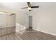 Bedroom with wood-look floors and mirrored closet doors at 4120 Scotmist Ct, Las Vegas, NV 89129