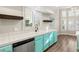 Kitchen with teal cabinets, stainless steel appliances, and white countertops at 4120 Scotmist Ct, Las Vegas, NV 89129