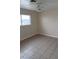 Well-lit bedroom with tile flooring, ceiling fan, and a large window offering views at 441 N 13Th St, Las Vegas, NV 89101