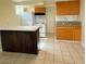 Cozy kitchen with wood cabinets, granite countertops, white appliances, and an island at 447 N 13Th St, Las Vegas, NV 89101