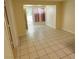 A bright, spacious living room with neutral walls, tile flooring, and a door to the patio at 447 N 13Th St, Las Vegas, NV 89101