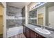 Bathroom with gray tile shower, granite vanity, and white sink at 4516 Townwall St, Las Vegas, NV 89115