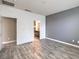 Bright bedroom with gray accent wall and wood-look flooring at 4516 Townwall St, Las Vegas, NV 89115