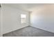 Simple bedroom with grey carpet and a large window at 4516 Townwall St, Las Vegas, NV 89115