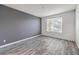 Bedroom with grey accent wall and wood-look floors at 4516 Townwall St, Las Vegas, NV 89115