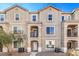 Tan three-story townhome with balconies and a two-car garage at 4516 Townwall St, Las Vegas, NV 89115