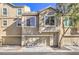 Tan two-story townhome with attached two-car garage at 4516 Townwall St, Las Vegas, NV 89115