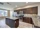 Modern kitchen with dark cabinetry, granite island, and stainless steel appliances at 4516 Townwall St, Las Vegas, NV 89115