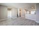 Spacious living area with stairs to upper level and kitchen access at 4516 Townwall St, Las Vegas, NV 89115