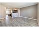 Open living area with wood-look flooring and kitchen views at 4516 Townwall St, Las Vegas, NV 89115