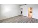 Main bedroom with grey laminate floors and an ensuite bathroom at 4516 Townwall St, Las Vegas, NV 89115