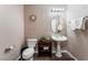 Small bathroom with pedestal sink and toilet at 5522 Oakview Falls Ct, Las Vegas, NV 89148