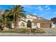 House with a landscaped front yard, featuring a fountain and palm trees at 5522 Oakview Falls Ct, Las Vegas, NV 89148