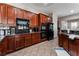 Well-equipped kitchen with dark wood cabinets, stainless steel appliances, and ample counter space at 5522 Oakview Falls Ct, Las Vegas, NV 89148