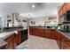 Large kitchen with an island, dark wood cabinets, and granite countertops at 5522 Oakview Falls Ct, Las Vegas, NV 89148