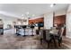 Kitchen boasts a large island with seating, dark wood cabinetry, and modern appliances at 5522 Oakview Falls Ct, Las Vegas, NV 89148