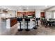 Modern kitchen with a breakfast bar, dark wood cabinets, and tile floors at 5522 Oakview Falls Ct, Las Vegas, NV 89148