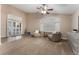 Bright living room with tile and carpet flooring, featuring comfy seating and access to a patio at 5522 Oakview Falls Ct, Las Vegas, NV 89148