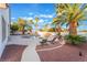 Relaxing pool area with lounge chairs and landscaping at 5522 Oakview Falls Ct, Las Vegas, NV 89148