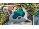 Irregular shaped pool with waterfall feature and surrounding landscaping at 5522 Oakview Falls Ct, Las Vegas, NV 89148