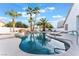 Relaxing pool area with palm trees and patio furniture at 5522 Oakview Falls Ct, Las Vegas, NV 89148