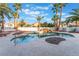 Inviting pool with waterfall feature and lounge chairs at 5522 Oakview Falls Ct, Las Vegas, NV 89148