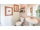 Stylish powder room with a pedestal sink and terracotta accents at 5709 Scarlet Rock St, North Las Vegas, NV 89081