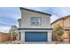 Modern two-story home with blue garage door and landscaped front yard at 5709 Scarlet Rock St, North Las Vegas, NV 89081