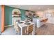 Modern kitchen with gray cabinets, white island, and teal accent wall at 5709 Scarlet Rock St, North Las Vegas, NV 89081