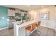 Modern kitchen with gray cabinets, white quartz countertops, and stainless steel appliances at 5709 Scarlet Rock St, North Las Vegas, NV 89081