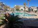 Inviting kidney-shaped pool with lounge chairs and patio furniture at 5710 E Tropicana Ave # 2148, Las Vegas, NV 89122